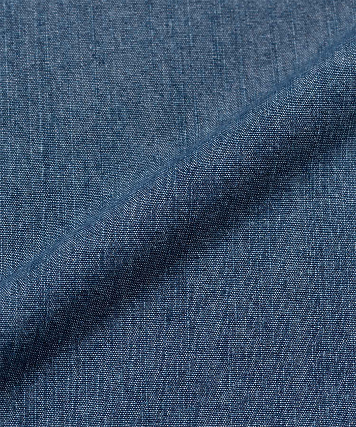 Close-up of Gramicci Japanese Chambray Double Knee pant blue denim fabric with a subtle pattern.