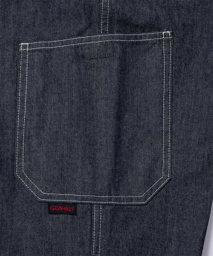Back view close-up of Japanese Chambray Rock Slide Pants pocket in the color navy against a light-tone background.