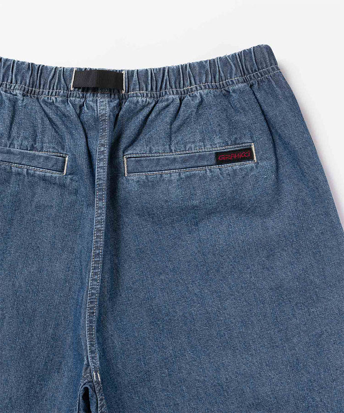 Back view close-up of blue Gramicci Japanese Chambray Shorts on a light-tone background.
