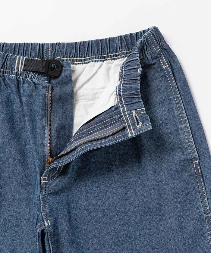 Close-up view of blue Gramicci Japanese Chambray Shorts on a light-tone background.