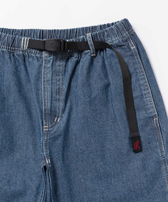Close-up view of blue Gramicci Japanese Chambray Shorts on a light-tone background.