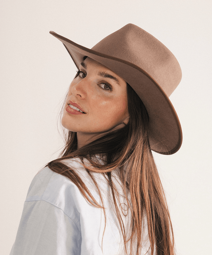 Woman wearing a brown felt hat on a white background #color_brown