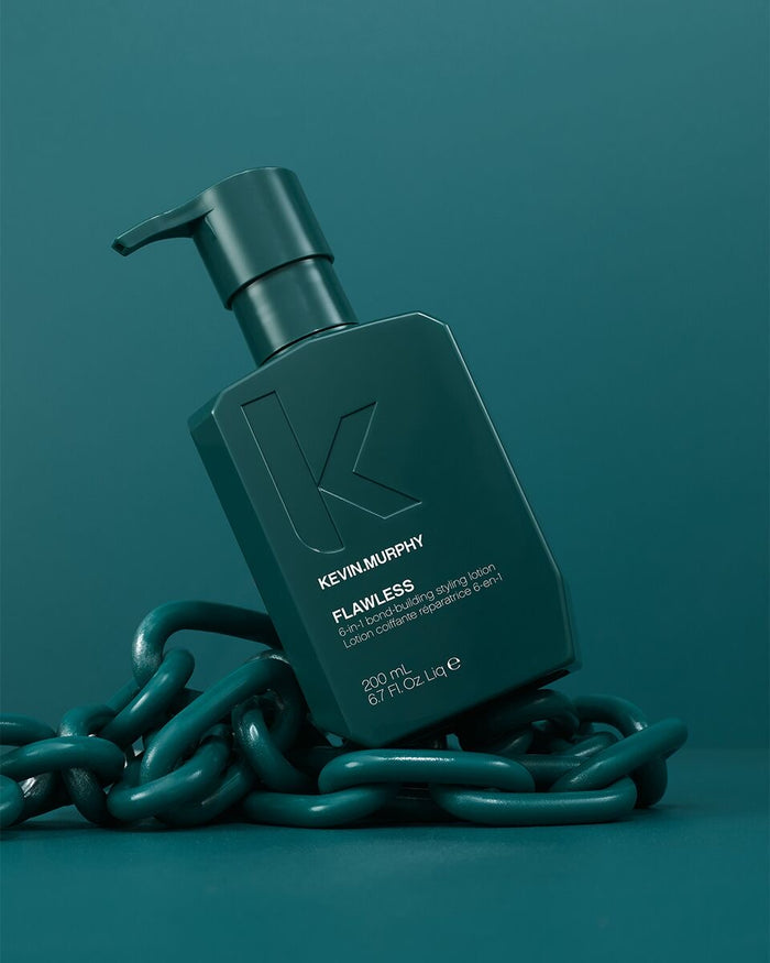 Kevin Murphy Flawless hair shampoo in a dark teal bottle, styled with a dark teal chain on a matching teal background - Hair Care Canada