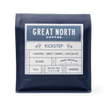 Kickstep coffee bag by Great North Coffee with a blue label and vintage farm illustration