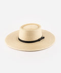A natural colored straw boater hat with a wide brim, featuring a black genuine leather band. #color_natural