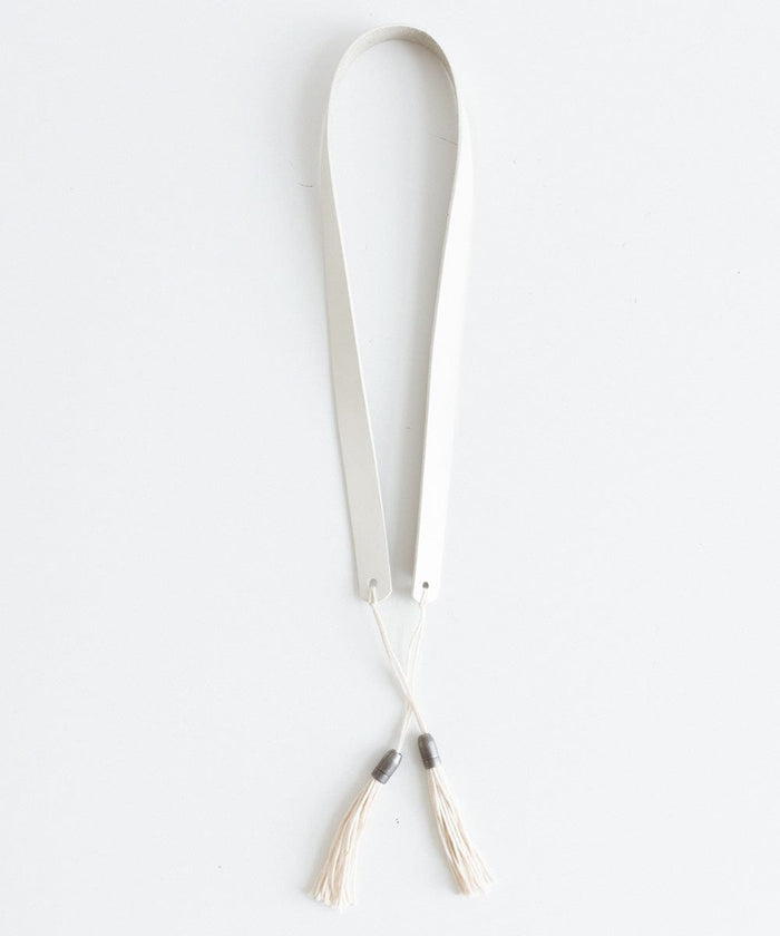 An off white leather band with tassels on a white background #color_off white
