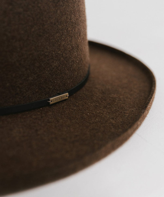 A close up image of a mix brown Lennon Pencil Brim Fedora Hat with a hat band against a plain background #color_mix brown
