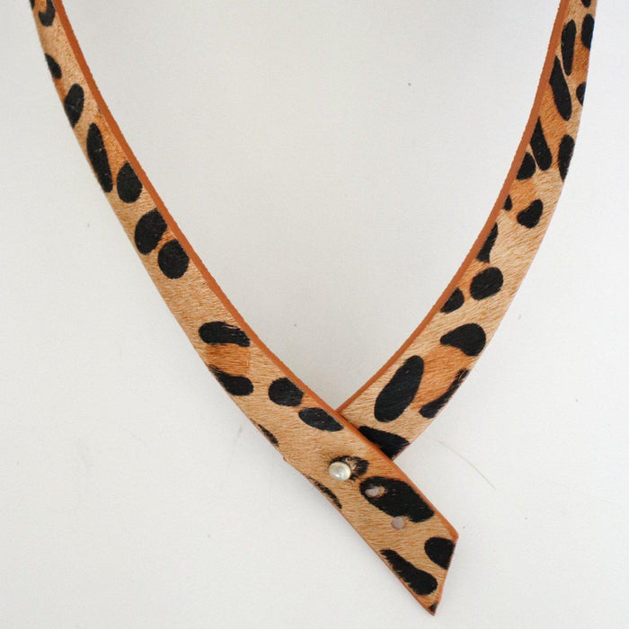 A tan leopard print hat band on a plain background #color_tan