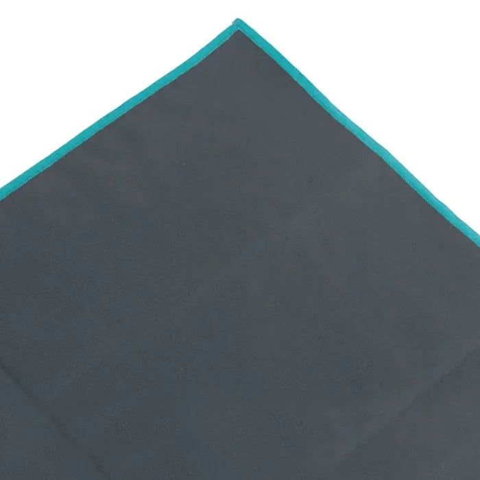 Close-up shot of the corner of a giant Lifeventure SoftFibre recycled travel towel in grey showing the sealed stitched edges