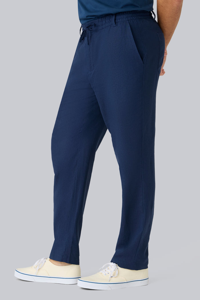 Side view of a man wearing Linen Drawstring Pant in True Navy