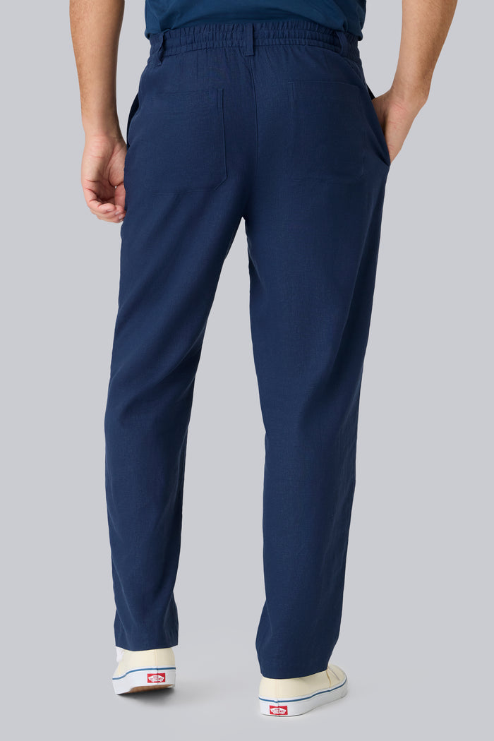 Back view of a man wearing Linen Drawstring Pant in True Navy