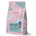 Little Buddy coffee bag from Olympia Coffee Roasting Company with colorful pink and teal artwork and award badges