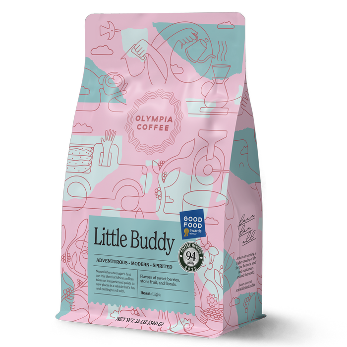 Little Buddy coffee bag from Olympia Coffee Roasting Company with colorful pink and teal artwork and award badges
