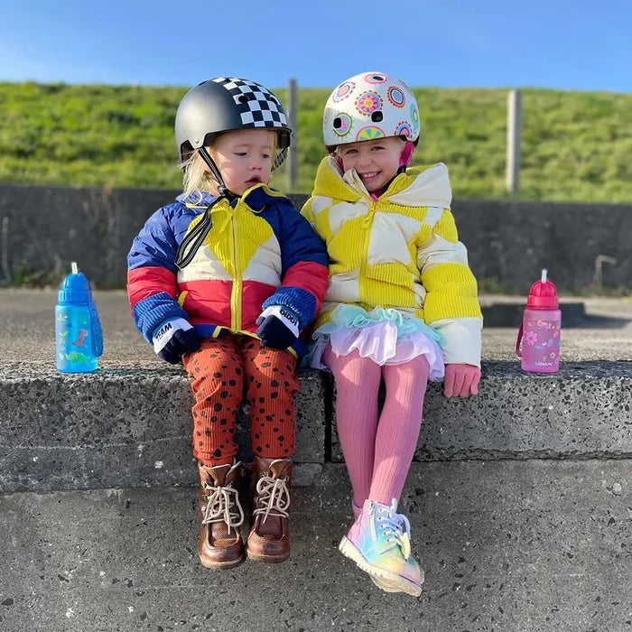 Two children sitting on a breakwater at the beach with Littlelife Kids Plastic Water Bottle s