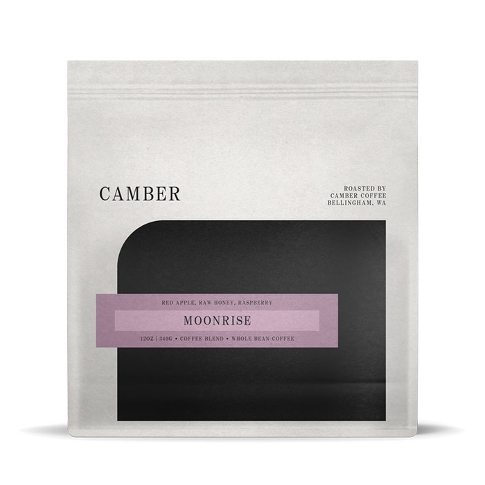 Camber Coffee Moonrise blend bag with lavender label on a light bag over a black rounded inset.