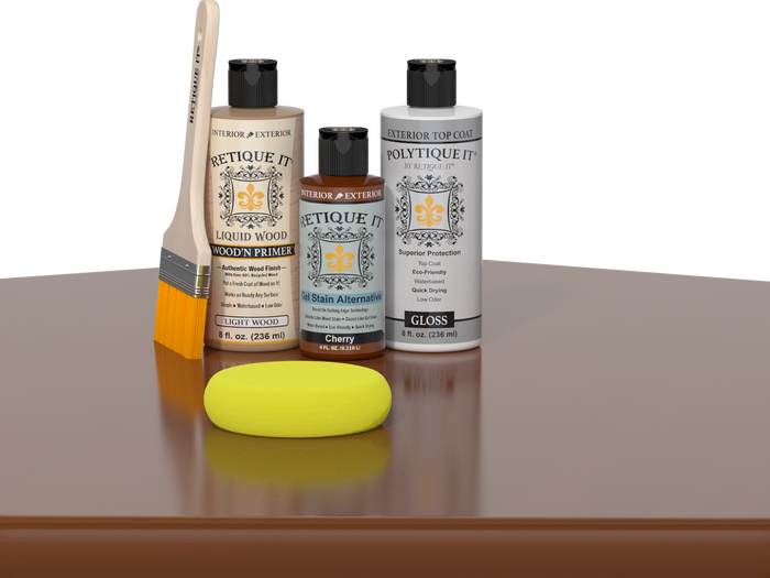 Retique It® Light Wood Wood’n Primer with Cherry Gel Stain Alternative, gloss topcoat, brush, and yellow sponge on a reflective tabletop.