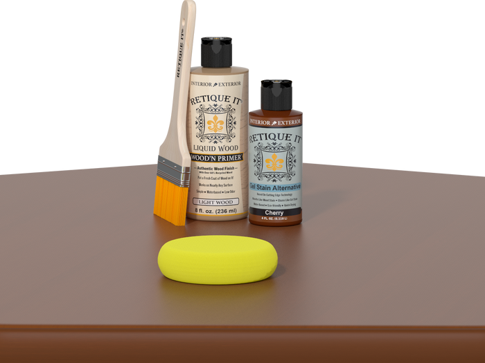 Retique It® Cherry Kit with Light Wood’n Primer, Cherry Gel Stain Alternative, paintbrush, and yellow sponge on a cherry wood tabletop.