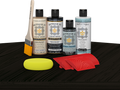Retique It® Classic Black Wood'n Kit with Light Wood primer, Classic Black stain, Classic Black gel stain alternative, Matte Tripletique® Top Coat, brush, red graining tool, and yellow sponge.
