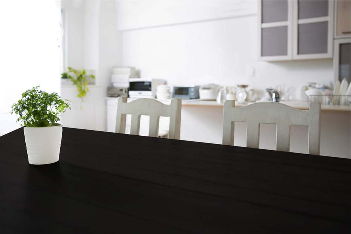 Retique It Wood'n Kit Multi-purpose Interior Top Coat on a wooden tabletop with black finish, showcasing smooth, professional wood surface.