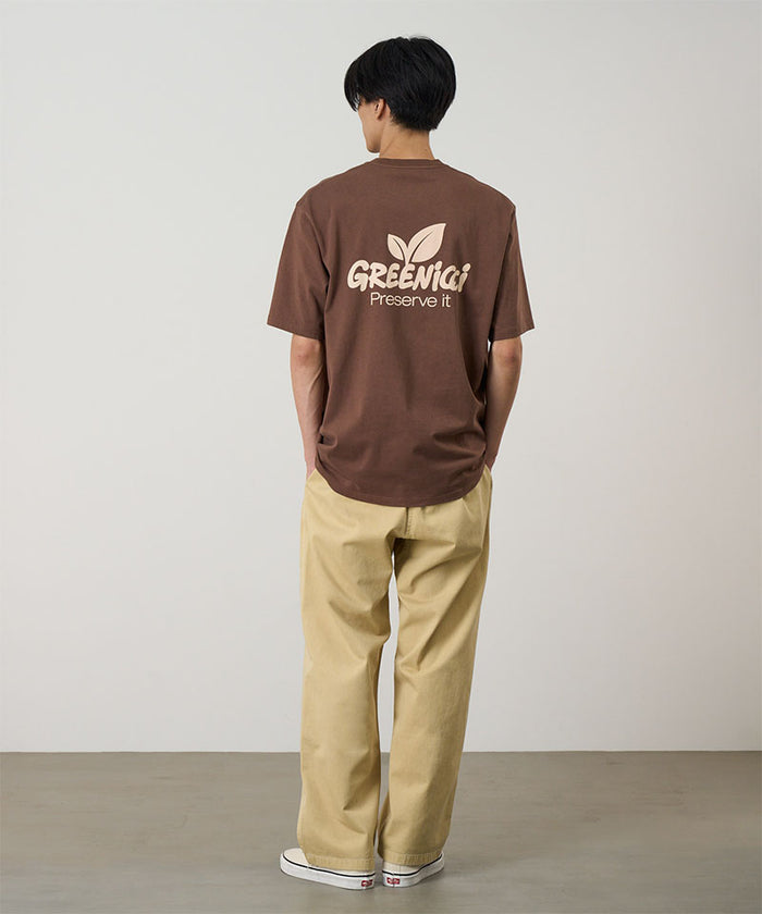 Back view of a model wearing a Natural Dyed Gramicci Pant Straight Fit in the color chino and brown shirt on a light-tone background.