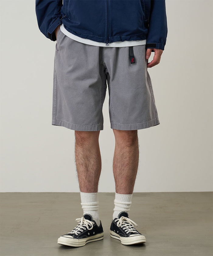 Model wearing a Gramicci Natural Dyed Jam Short in the color grey on a light-tone background.