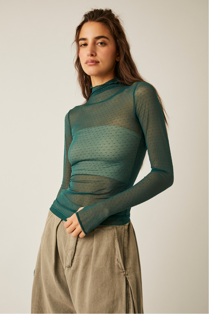 Woman wearing Free People On The Dot Layering in Evergreen against white background