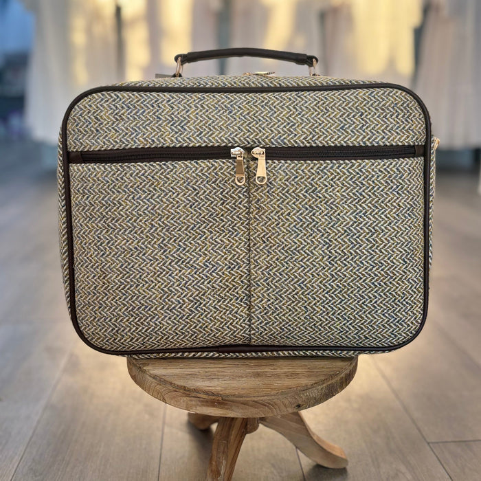 Suitcase style bag with zippers.