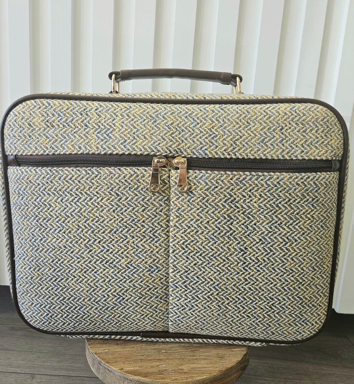 Suitcase style bag with zippers.