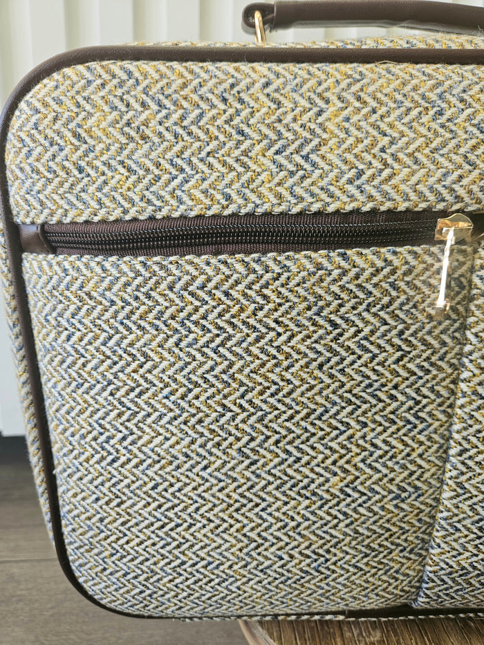 Suitcase style bag with zippers.