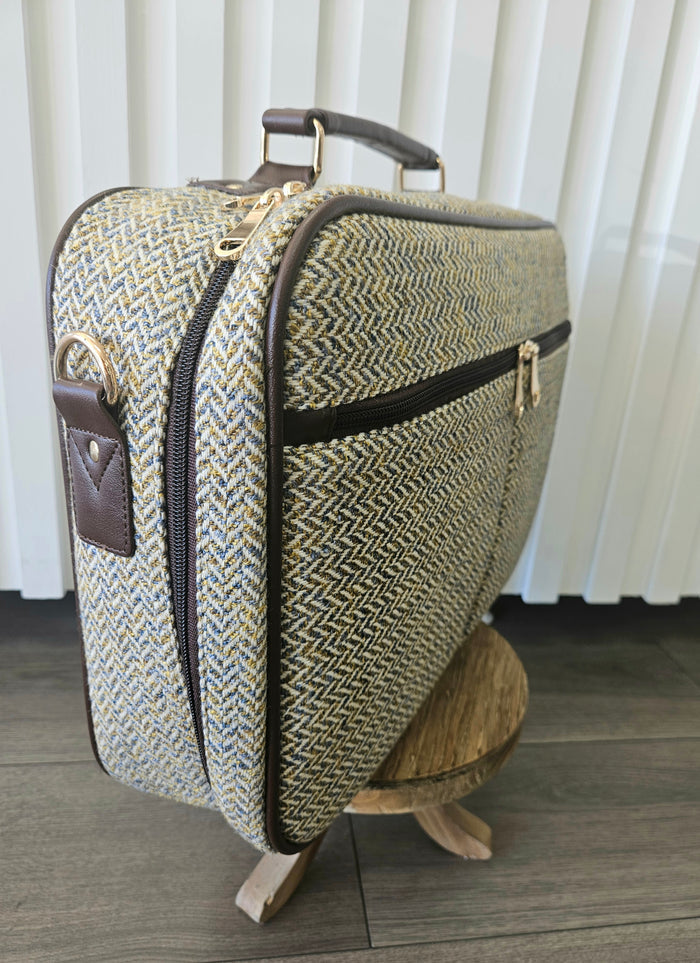 Suitcase style bag with zippers.
