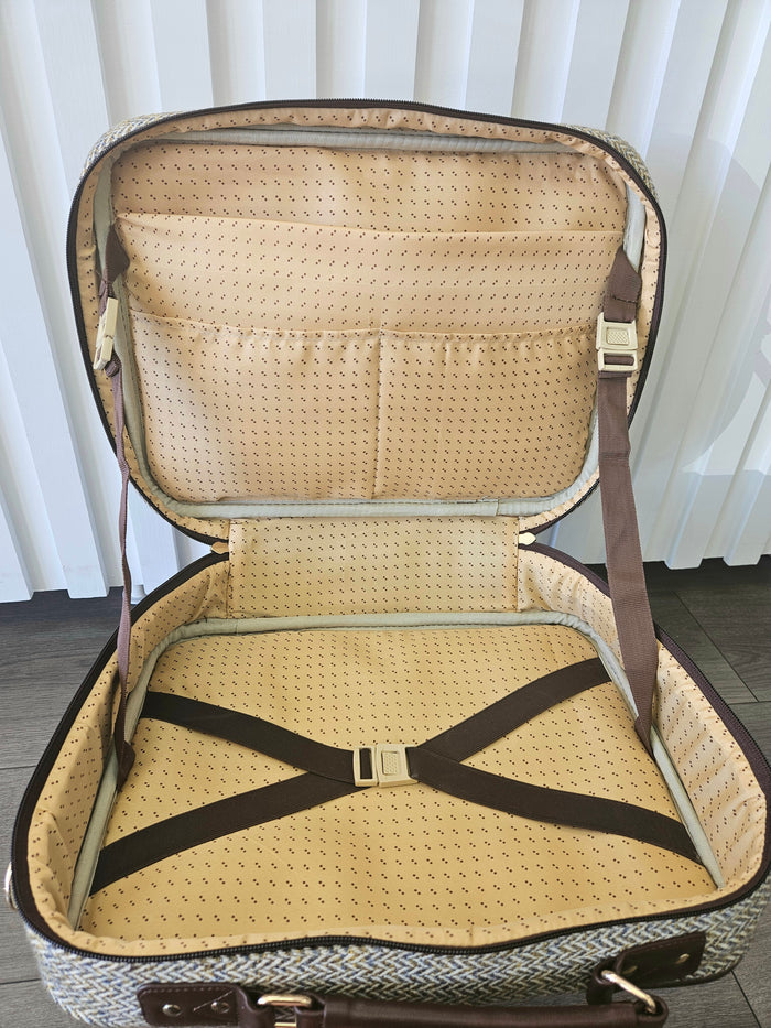 Open suitcase style bag with zippers.