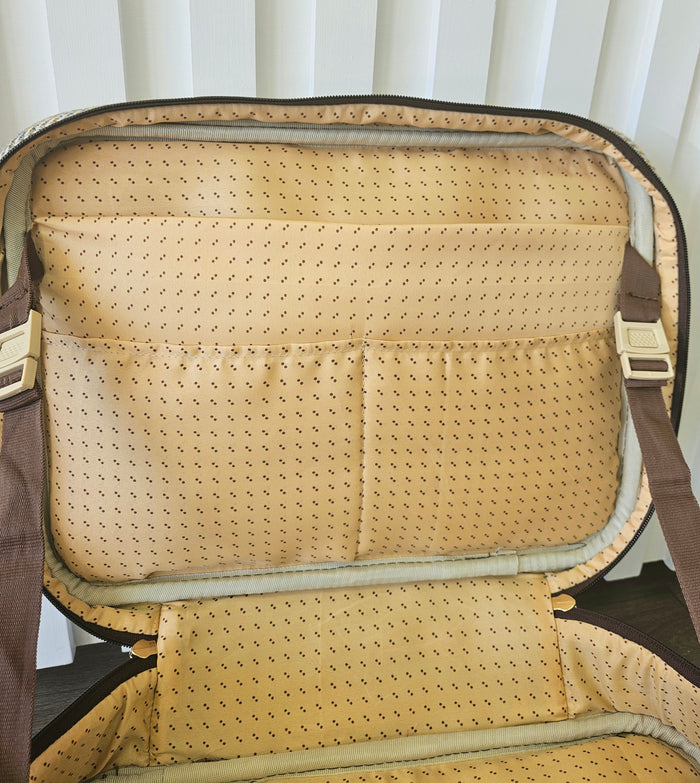 Open suitcase style bag with zippers.