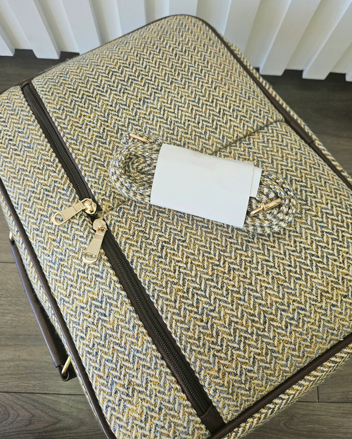 Suitcase style bag with zippers and detachable strap.