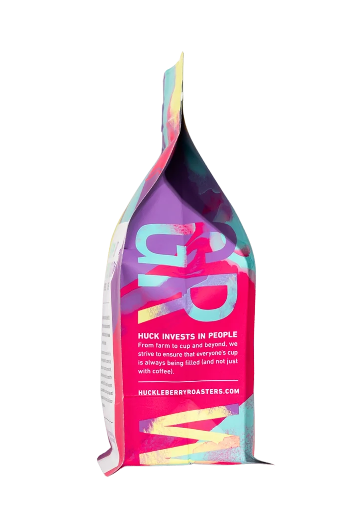 Phantom Limb coffee bag with a multicolored abstract design rising from the bottom against a black background.