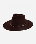 A dark cherry colored wide brim fedora hat with a gold chain detail around the base of the crown on a plain background #color_dark cherry