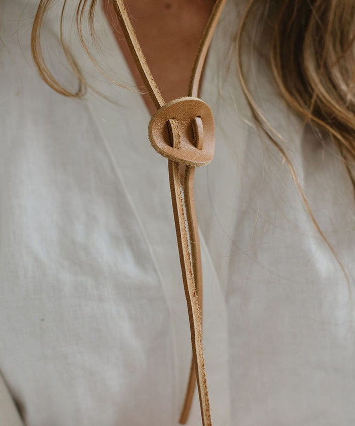 Brown chinstrap of a hat worn by a person #color_ivory