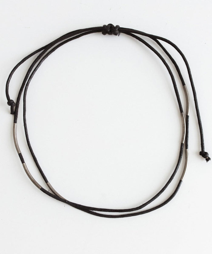 A black rope band with beads on a white background #color_black
