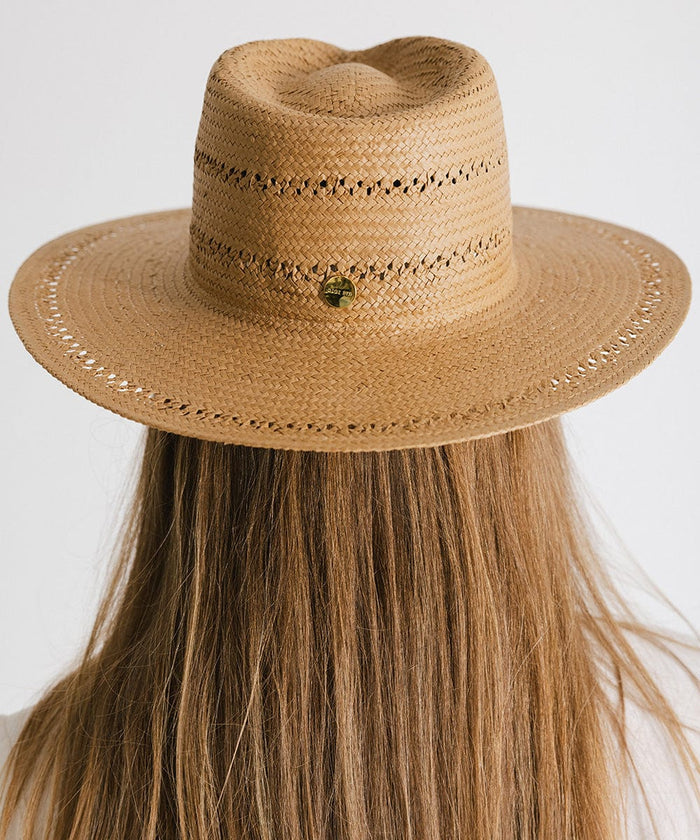 Woman with long hair wearing a honey colored teardrop straw fedora hat facing behind against a plain background #color_honey
