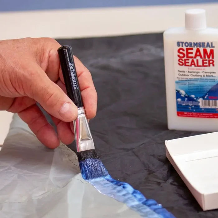 Stormseal Emergency Fabric Waterproof Seam Sealer being applied with the applicator brush to stitching on a tent