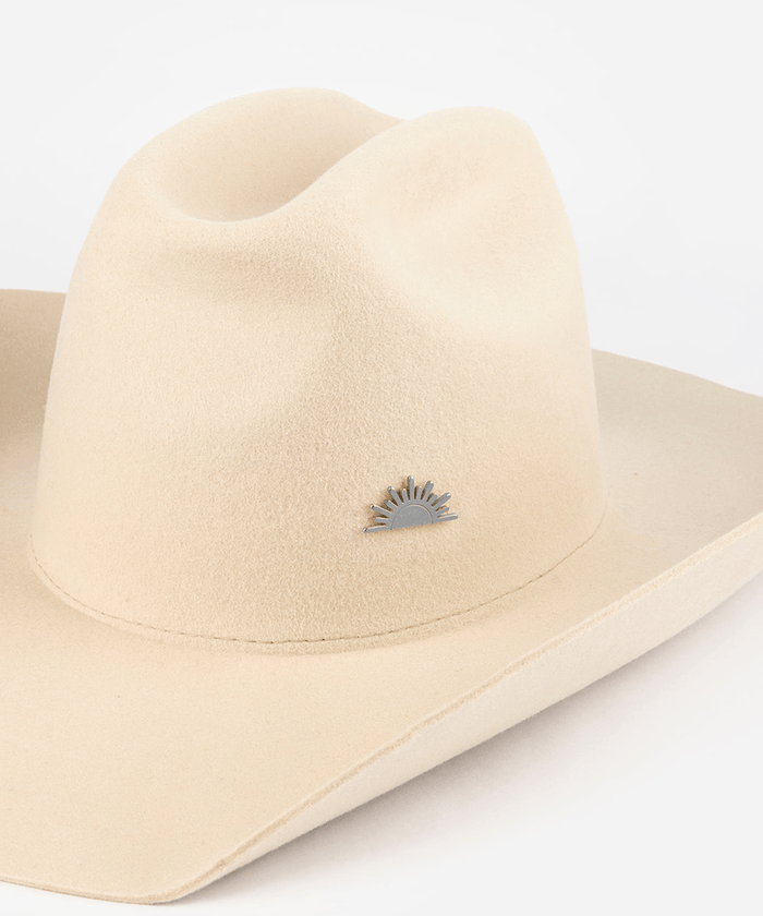 Pink cowboy hat with a silver sun-shaped hat pin on a white background #color_silver
