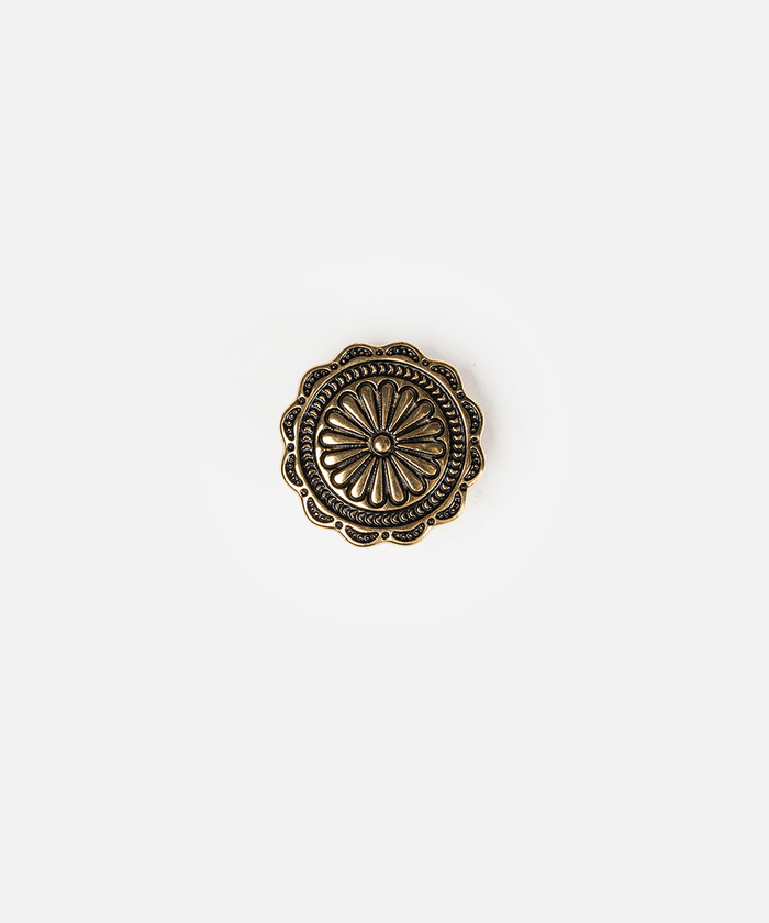An antique bronze decorative button with a floral sunburst pattern and scalloped edges, centered on a plain light gray background #color_gold