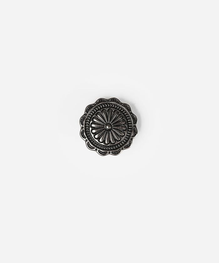 A single round, scalloped metal button with an embossed floral or sunburst pattern, shown on a plain light gray background #color_silver