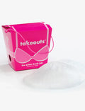 A clear breast enhancing insert with a pink box in the background labeled 'takeouts' with a graphic of a bra on it.