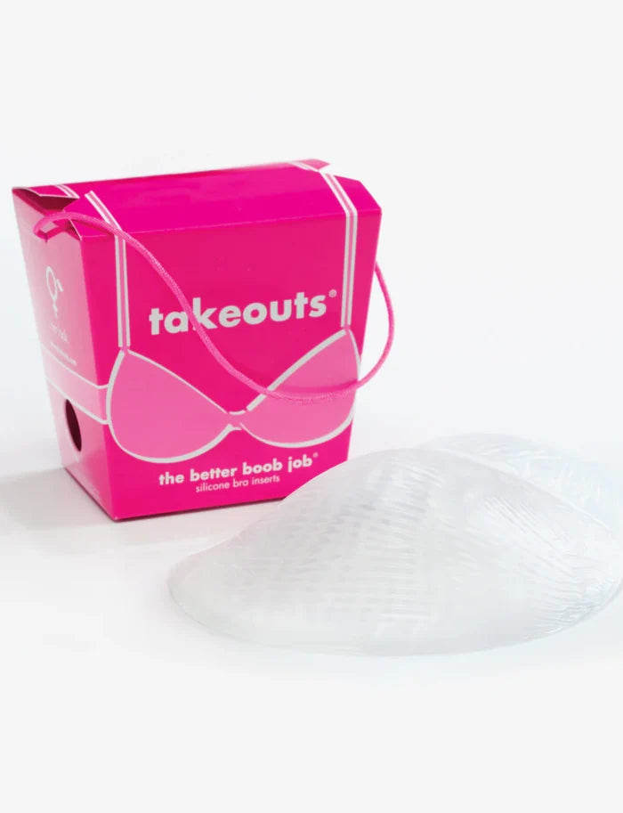 A clear breast enhancing insert with a pink box in the background labeled 'takeouts' with a graphic of a bra on it.