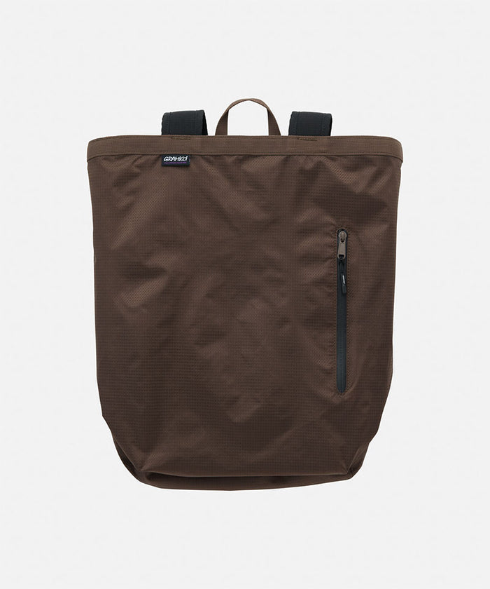 Brown Gramicci Tote Pack bag against a light-tone background.