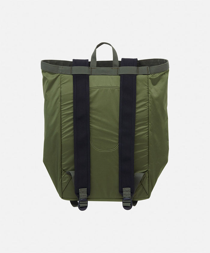 Back view of an olive Gramicci Tote Pack bag against a light-tone background.