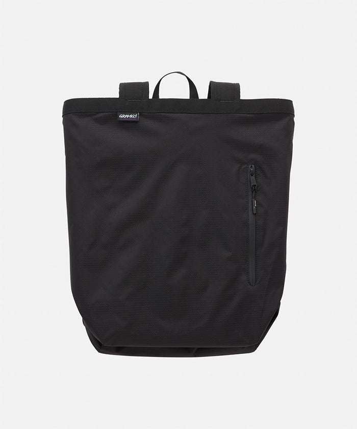 Black Gramicci Tote Pack bag against a light-tone background.