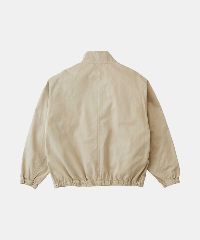 Back view of a Gramicci chino colored Twill-Around Jacket against a light-tone background.