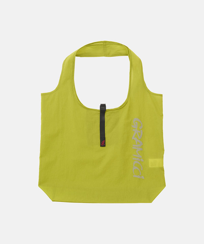 Kiwi yellow Gramicci reuseable Ultra-Light Shopper against a light-tone background.