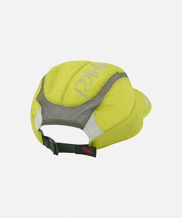 Back view of a Kiwi green Gramicci Ultra-Light Tech Cap with gray mesh and black strap on a light tone background